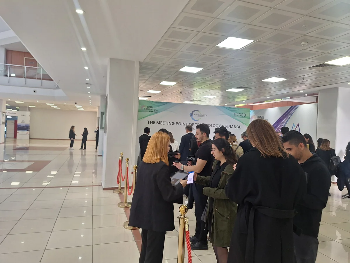 Attendees lining up for badge check-in at Agora Fintech Week, an event run on Moostoo