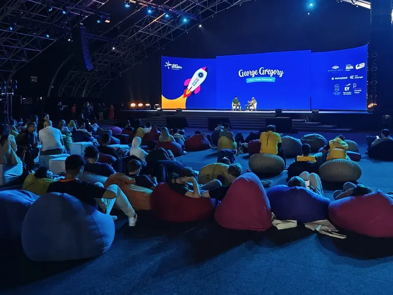 Conference audience on beanbags watching a main-stage speaker session