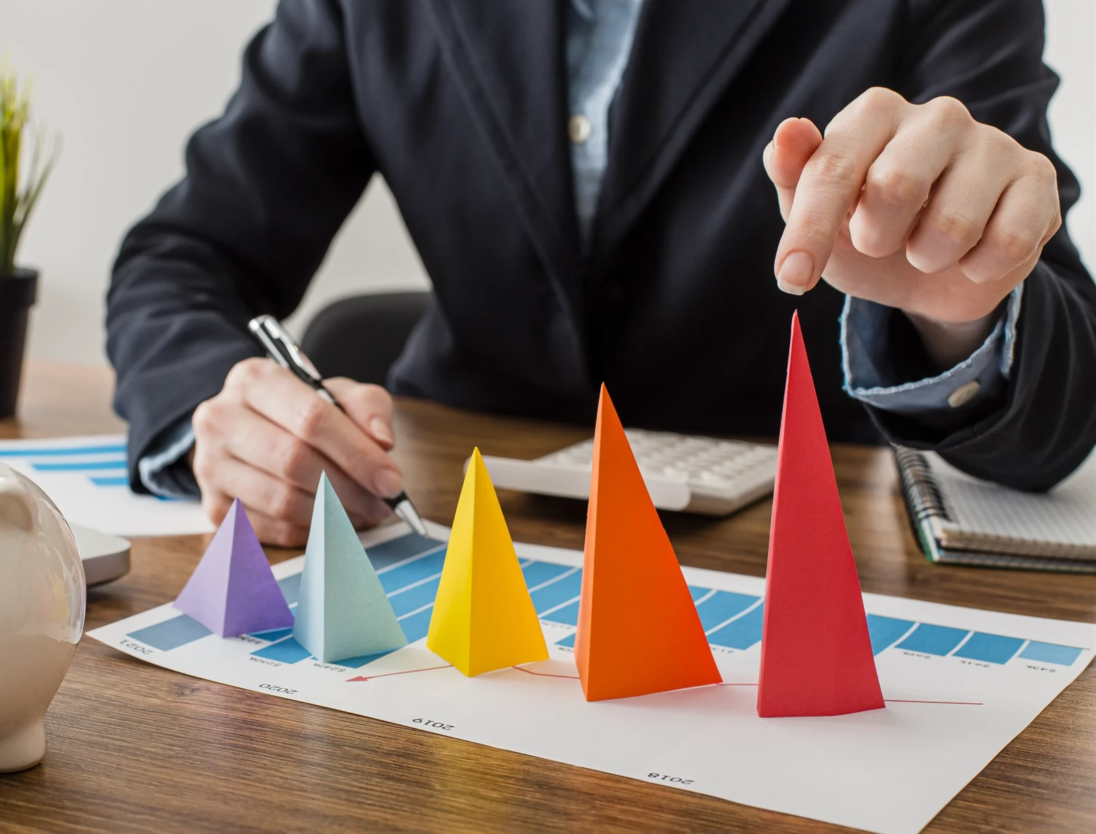 Colorful paper cones of rising height on a bar chart, representing event ROI growth